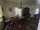 Dining room with chandelier, wood table, hutch and patterned red rug at 25 Candler Se Rd, Atlanta, GA 30317