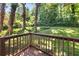 An eye-level deck view of a lush, green backyard surrounded by mature trees at 2923 Akron St, East Point, GA 30344