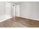 A neutral bedroom showcasing light gray walls and laminate wood flooring with white doors and trim at 2923 Akron St, East Point, GA 30344