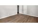 Bedroom featuring wood-look floors, gray walls, and closet space at 2923 Akron St, East Point, GA 30344