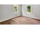 This bedroom features pristine gray walls, light-filled windows, and laminate wood flooring at 2923 Akron St, East Point, GA 30344