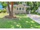 Charming bungalow with a well-maintained front yard, mature trees, and inviting entrance at 2923 Akron St, East Point, GA 30344