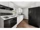 Efficient kitchen with white cabinets, black appliances, and modern sink at 2923 Akron St, East Point, GA 30344