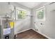 Bright laundry room with gray walls, wood-look floors, and natural light at 2923 Akron St, East Point, GA 30344