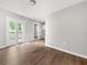 Living room with gray walls, wood-look floors, and natural light from a back patio door at 2923 Akron St, East Point, GA 30344