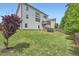 Backyard view of a two story house with a deck, lawn and wooden fence at 7820 Bristol Valley Dr, Cumming, GA 30028