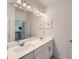 Bathroom featuring double sinks, large mirror, and neutral decor at 7820 Bristol Valley Dr, Cumming, GA 30028