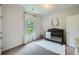 Bedroom with dark crib, plush rug, and a window offering natural light at 7820 Bristol Valley Dr, Cumming, GA 30028