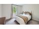 This is a cozy bedroom with neutral walls, carpet flooring, and a window overlooking the trees at 7820 Bristol Valley Dr, Cumming, GA 30028