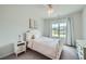 Bedroom with white furniture, tufted headboard and neutral-toned decor at 7820 Bristol Valley Dr, Cumming, GA 30028