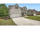 Side view of a white brick two-story house with a long driveway leading to an attached garage at 7820 Bristol Valley Dr, Cumming, GA 30028