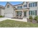 A two-story home with white brick, black shutters, and a covered front porch, perfect for relaxing outdoors at 7820 Bristol Valley Dr, Cumming, GA 30028