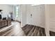 Inviting foyer with wood-look floors, a white door, and a view into a bright office space at 7820 Bristol Valley Dr, Cumming, GA 30028