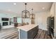Bright kitchen features a gray island with quartz countertops, stainless steel appliances and an open floor plan at 7820 Bristol Valley Dr, Cumming, GA 30028