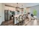 Modern kitchen with stainless steel appliances, white cabinets, and an island with seating, perfect for entertaining at 7820 Bristol Valley Dr, Cumming, GA 30028