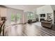 This open concept space features a living room with a fireplace and a sliding door to the outside deck at 7820 Bristol Valley Dr, Cumming, GA 30028