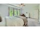 Bright main bedroom features neutral walls, carpet flooring, windows overlooking trees and a tray ceiling at 7820 Bristol Valley Dr, Cumming, GA 30028