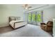Spacious primary bedroom features neutral walls, carpet flooring, and three windows with natural light at 7820 Bristol Valley Dr, Cumming, GA 30028