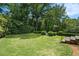 Expansive backyard featuring lush green lawn and mature trees providing privacy and shade at 927 Berkshire Ne Rd, Atlanta, GA 30324