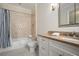 Bathroom boasts a shower-tub combo, tiled floors, and a vanity with ample storage space at 927 Berkshire Ne Rd, Atlanta, GA 30324