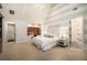 Bedroom with striped accent wall, chandelier, and ensuite bathroom at 927 Berkshire Ne Rd, Atlanta, GA 30324