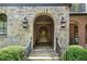 Arched stone entryway with dark metal fixtures and a brick facade at 927 Berkshire Ne Rd, Atlanta, GA 30324