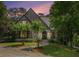 Beautiful brick Tudor-style home with landscaped front yard and stone walkway to the arched front door at 927 Berkshire Ne Rd, Atlanta, GA 30324