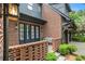 Charming brick home featuring a welcoming entrance with stylish double doors, elegant lighting and manicured landscaping at 927 Berkshire Ne Rd, Atlanta, GA 30324