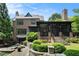 Elegant brick home with a screened-in porch, a stone patio, and lush landscaping at 927 Berkshire Ne Rd, Atlanta, GA 30324