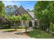 Brick Tudor-style home with manicured lawn and stone path leading to an arched entryway at 927 Berkshire Ne Rd, Atlanta, GA 30324