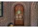 Detailed view of the beautiful front door, surrounded by brick and decorative window at 927 Berkshire Ne Rd, Atlanta, GA 30324