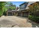 Attached three-car garage with a brick exterior and a spacious driveway for additional parking at 927 Berkshire Ne Rd, Atlanta, GA 30324