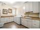 Functional laundry room featuring modern appliances, storage cabinets, and a utility sink at 927 Berkshire Ne Rd, Atlanta, GA 30324
