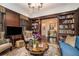 Cozy living room with a fireplace, wood paneling, and built-in bookshelves at 927 Berkshire Ne Rd, Atlanta, GA 30324