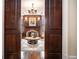 View through the doorway of a living room featuring a fireplace, dark wood paneling, and elegant decor at 927 Berkshire Ne Rd, Atlanta, GA 30324