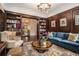 Charming living room featuring wood paneling, built-in bookshelves, and a comfortable seating area at 927 Berkshire Ne Rd, Atlanta, GA 30324