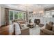 Bright living room with fireplace, large windows, hardwood floors, and neutral decor at 927 Berkshire Ne Rd, Atlanta, GA 30324
