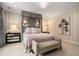 Cozy main bedroom showcasing striped wallpaper, soft lighting, and elegant furnishings for a peaceful retreat at 927 Berkshire Ne Rd, Atlanta, GA 30324