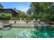 Gorgeous pool area with a stone patio, lush landscaping, and a spa for ultimate relaxation at 927 Berkshire Ne Rd, Atlanta, GA 30324