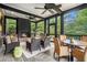Inviting screened porch with a fireplace, comfortable seating, and ceiling fans for year-round enjoyment at 927 Berkshire Ne Rd, Atlanta, GA 30324