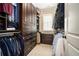 Well-organized walk-in closet with custom wood cabinetry, shelving, and ample hanging space for clothing storage at 927 Berkshire Ne Rd, Atlanta, GA 30324