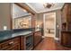 A stylish wet bar is equipped with a wine fridge, a sink, and custom cabinets for storage at 927 Berkshire Ne Rd, Atlanta, GA 30324