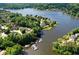 Picturesque aerial view showcasing lakefront homes, lush trees, and a marina at 1010 Graystone Xing, Alpharetta, GA 30005