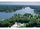 Picturesque aerial view of a community on a lake surrounded by lush trees and community pools at 1010 Graystone Xing, Alpharetta, GA 30005