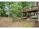 A raised wood deck with ample space below amidst a serene backyard setting at 1010 Graystone Xing, Alpharetta, GA 30005
