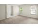 Inviting bedroom with carpet flooring, natural light from windows, and an ensuite bathroom at 1010 Graystone Xing, Alpharetta, GA 30005