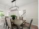 Elegant dining room featuring a modern chandelier and access to the living room and staircase at 1010 Graystone Xing, Alpharetta, GA 30005