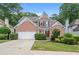 Charming two-story brick home with a well-manicured lawn and a two-car garage at 1010 Graystone Xing, Alpharetta, GA 30005