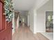 Bright entryway with hardwood floors, chandelier, staircase, and dining room at 1010 Graystone Xing, Alpharetta, GA 30005