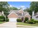 Beautiful two-story brick home with a manicured lawn and a two car garage at 1010 Graystone Xing, Alpharetta, GA 30005